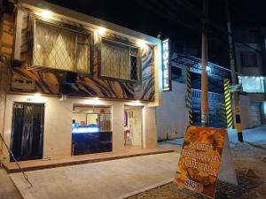 a building under construction with a sign in front of it at Hotel Antonela Amorim in Barrio Centenario