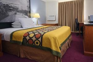 a hotel room with a bed and a desk at Algona Inn in Algona