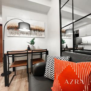 a living room with a table and a couch at Zara at Mesavirre Bacolod in Bacolod +1 photo