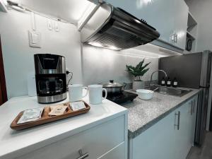 a kitchen with a coffee maker on a counter at Zara at Mesavirre Bacolod in Bacolod
