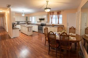 a large kitchen with a table and chairs in it at Richmond cozy room in Richmond +27 photos