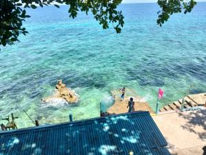a view of a beach with people in the water at Monique Beach Resort by Hiverooms in Carmen
