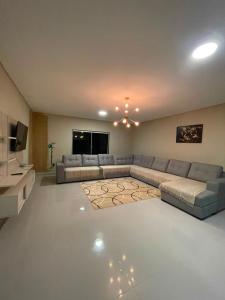 a large living room with a couch and a television at Pousada Recanto do Oásis in Triunfo