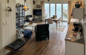 a living room with a couch and a table at 3 Bedroom Nice Home In Os in Oma