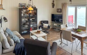 a living room with a couch and a table at 3 Bedroom Nice Home In Os in Oma