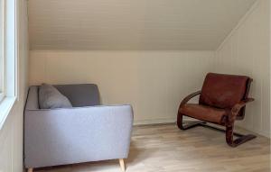 a living room with a couch and a chair at 3 Bedroom Nice Home In Os in Oma +11 photos