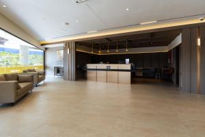 a lobby with couches and a bar in a building at Costa Hotel Nilai in Nilai