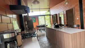 a kitchen with a counter and a stove top oven at SAMAY FOREST- MASHPI AMAGUSa in Mashpi