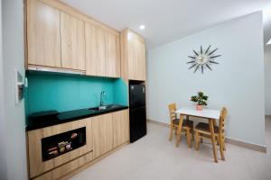 a kitchen with a table and a fish tank at Cherry Airport Hotel and Apartment 2 in Ho Chi Minh City