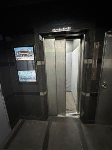 a hallway with an open door in a bathroom at Panda Home Umeda 01 in Osaka