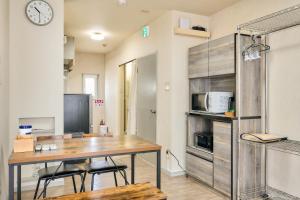 a kitchen with a table and chairs and a microwave at Bird Heights 101 in Furano
