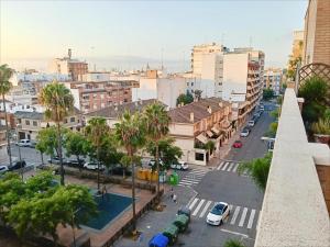 a view of a city street with palm trees at Encalma vacacional El Ático, terraza,garaje,playa in Puerto de Sagunto