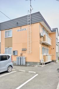 a building with a ladder on the side of it at Bird Heights 101 in Furano