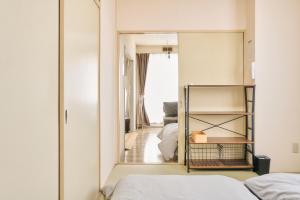 a bedroom with a mirror and a bed at Bird Heights 101 in Furano