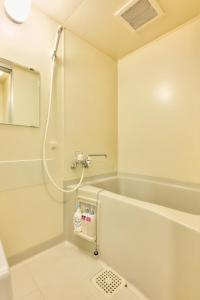 a bathroom with a shower and a bath tub at Bird Heights 101 in Furano +21 photos