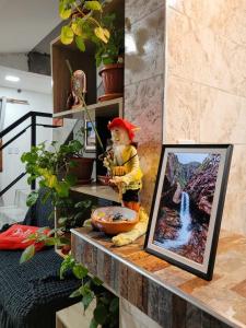 a picture of a statue on a counter with a picture of a waterfall at La Tía Rola in Humahuaca