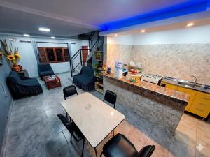 a kitchen with a table and chairs in a room at La Tía Rola in Humahuaca