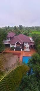 an aerial view of a large house with a yard at Siddhi farm in Kolhapur