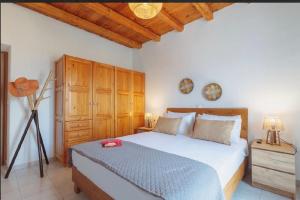 a bedroom with a bed and a wooden ceiling at Morning glow villa in Antiparos +87 photos