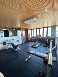 a gym with several treadmills and machines in a room at Cherry Airport Hotel and Apartment 2 in Ho Chi Minh City