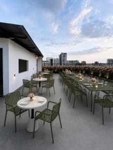 a row of tables and chairs on a roof at Cherry Airport Hotel and Apartment 2 in Ho Chi Minh City
