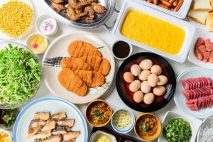 a table filled with different types of food on plates at KKR Hotel Nagoya in Nagoya