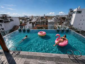 two people playing in a swimming pool on a building at Cherry Airport Hotel and Apartment 2 in Ho Chi Minh City