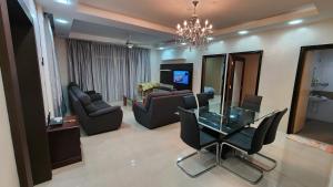 a living room with a glass table and chairs at Crown imperial in Brinchang