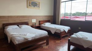 a room with two beds and a window at Hospedaje Maju Del Oriente in Pucallpa +8 photos