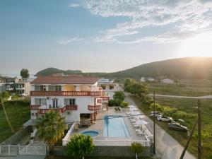 a view of a building with a swimming pool at Hotel Alexandros in Ammoudia