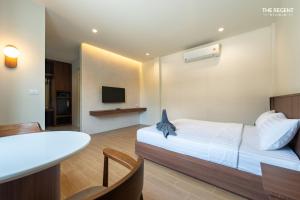 a hotel room with a bed and a dining table at The Regent Studio Kamala in Kamala Beach +43 photos
