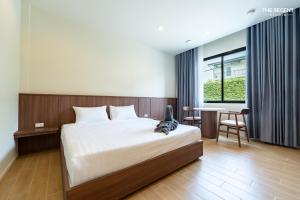 a bedroom with a bed and a table and chairs at The Regent Studio Kamala in Kamala Beach