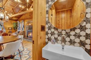 a kitchen and dining room with a sink and a table at Beartop Lodge Cozy Rustic Cabin Fire Pit in Blakeslee +21 photos