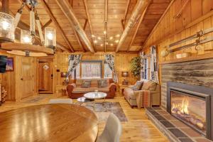 a living room with a fireplace in a log cabin at Beartop Lodge Cozy Rustic Cabin Fire Pit in Blakeslee