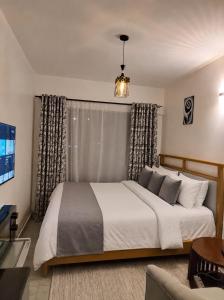 a bedroom with a large bed in a room at Imanis comfort in Ongata Rongai  +19 photos