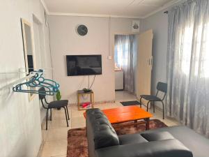 a living room with a couch and a table at 399 Place in Umtali