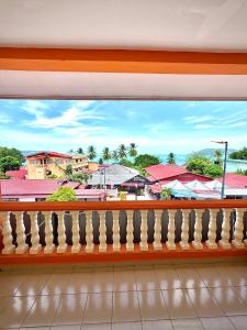 a balcony with a view of a city at Amzar Motel Cenang in Pantai Cenang