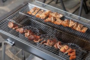 a bunch of food cooking on a grill at Gapyeong the Bay Resort in Gapyeong