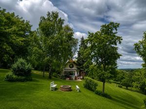 a house in the middle of a field with trees at KisHáz a Zselicben in Zselickisfalud