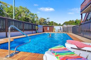 a swimming pool with a person in the water at Boat Harbour Stays in Hervey Bay