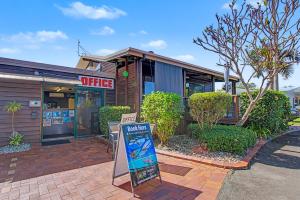 a coffee shop with a sign in front of it at Boat Harbour Stays in Hervey Bay