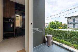 a kitchen with a large window and a table at The Regent Studio Kamala in Kamala Beach