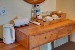 a wooden table with bowls and bottles on top of it at Aruna House in Ubud +61 photos