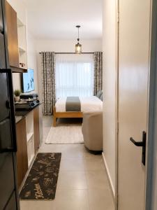 a small room with a bed and a window at Imanis comfort in Ongata Rongai 