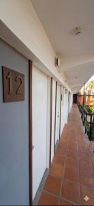a hallway of a building with a number on the wall at Hotel Palmas Quintero in Rosarito Beach