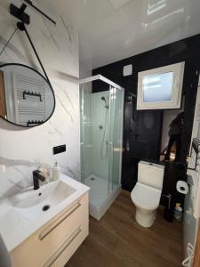 a bathroom with a shower and a toilet and a sink at Domki Na Talerzu in Skorochow +17 photos