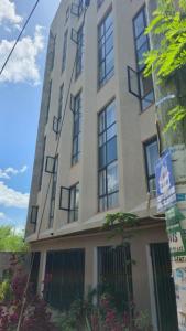 a tall building with windows on the side of it at Imanis comfort in Ongata Rongai 