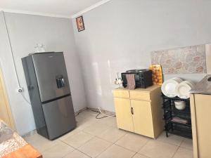 a kitchen with a stainless steel refrigerator in the corner at 399 Place in Umtali