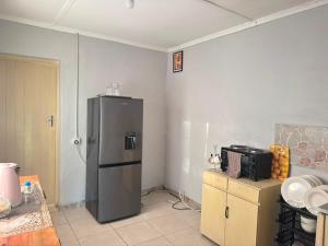 a kitchen with a stainless steel refrigerator in the corner at 399 Place in Umtali
