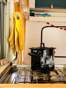 a black pot sitting on a stove in a kitchen at Camper Somá in Muonio